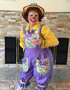 Rainbow the Clown holding a bottle of hand sanitizer