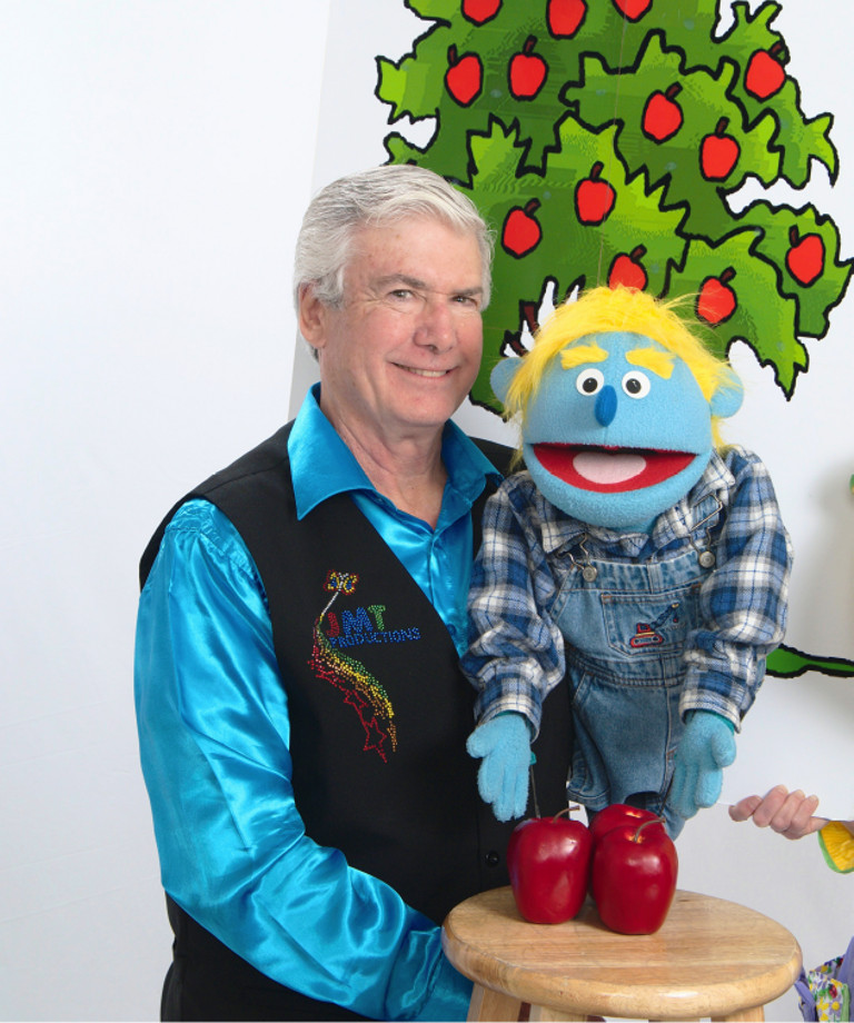 Mr. T and his puppet with three apples on a stool
