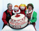 Mr. T, Rainbow, and two puppets with a large cake that says "Happy Birthday Jesus"