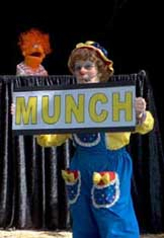 Rainbow holds a sign that says "munch"